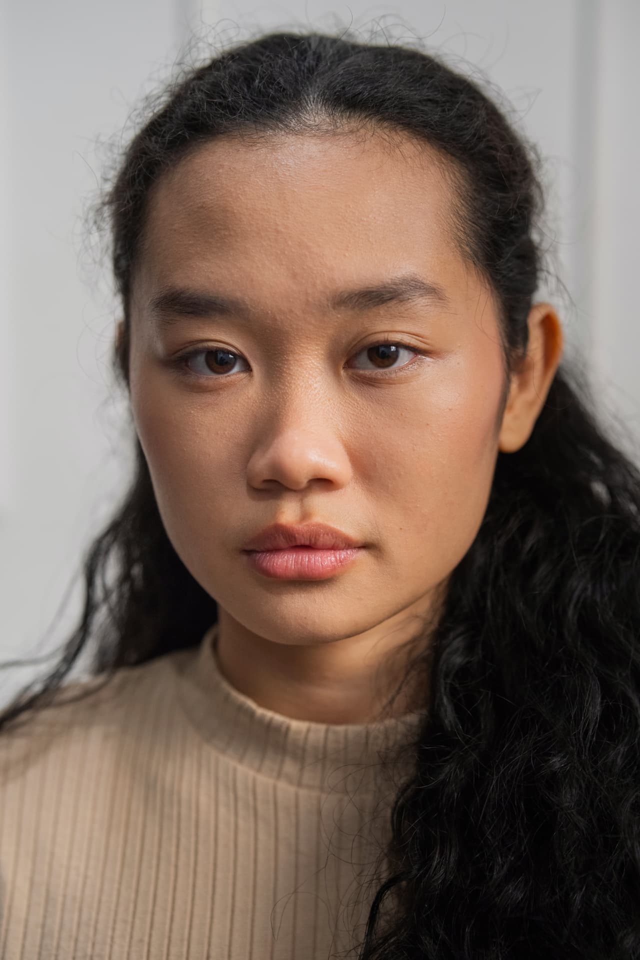 Amelia Ali close-up portrait in a beige ribbed top