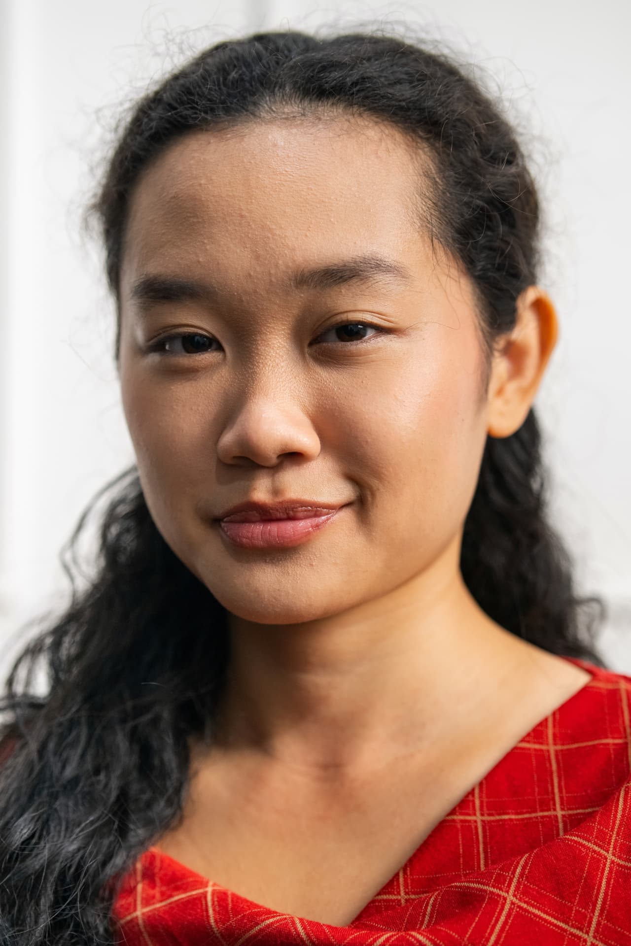 Amelia Ali close-up portrait with red patterned top and soft light