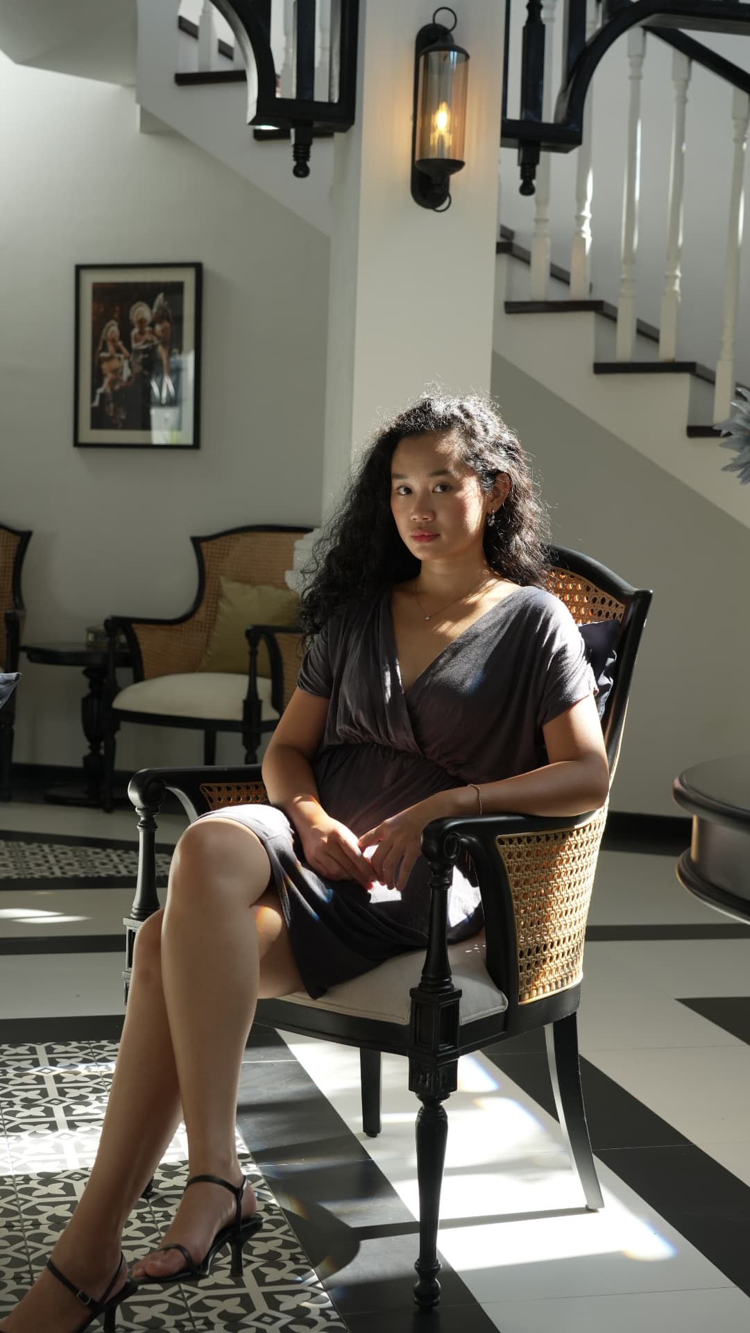 Amelia Ali seated portrait in colonial-style interior